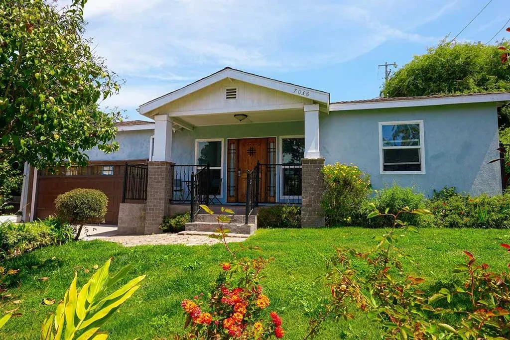 Residential home exterior with a front porch and garden